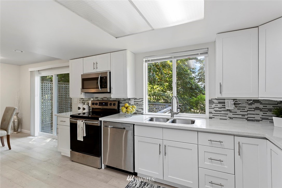 6609 Southeast 4th Place Renton, WA 98059 - Photo 10 of 26 a kitchen with a sink stove and microwave