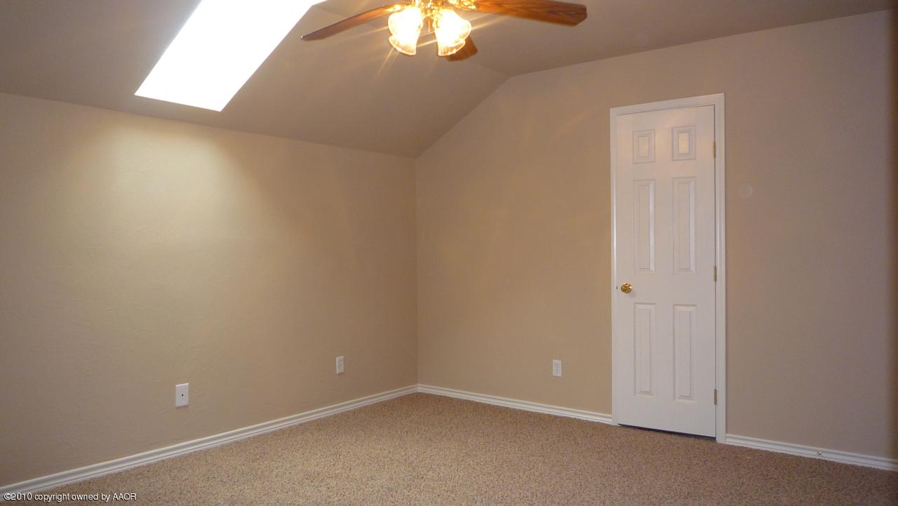 8950 Red Wing Road Amarillo, TX 79119 - Photo 15 of 29 an empty room with a chandelier fan