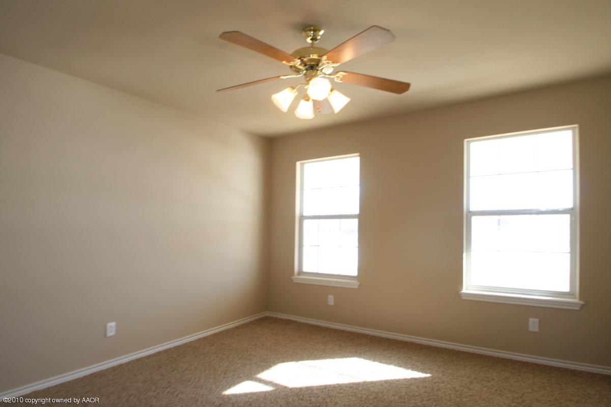 8950 Red Wing Road Amarillo, TX 79119 - Photo 21 of 29 an empty room with a window and a ceiling fan