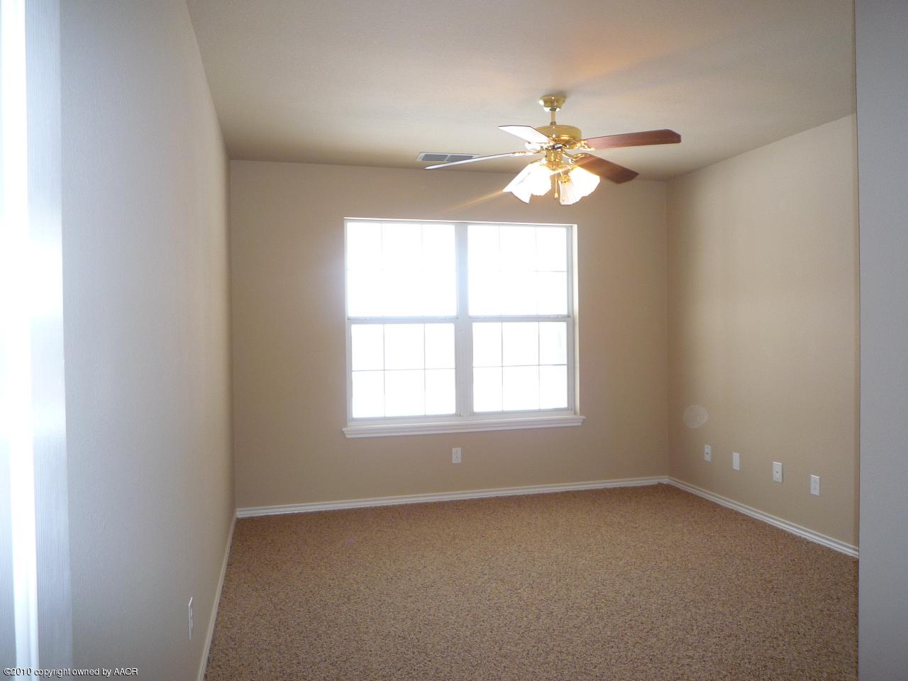 8950 Red Wing Road Amarillo, TX 79119 - Photo 22 of 29 an empty room with a window and a fan
