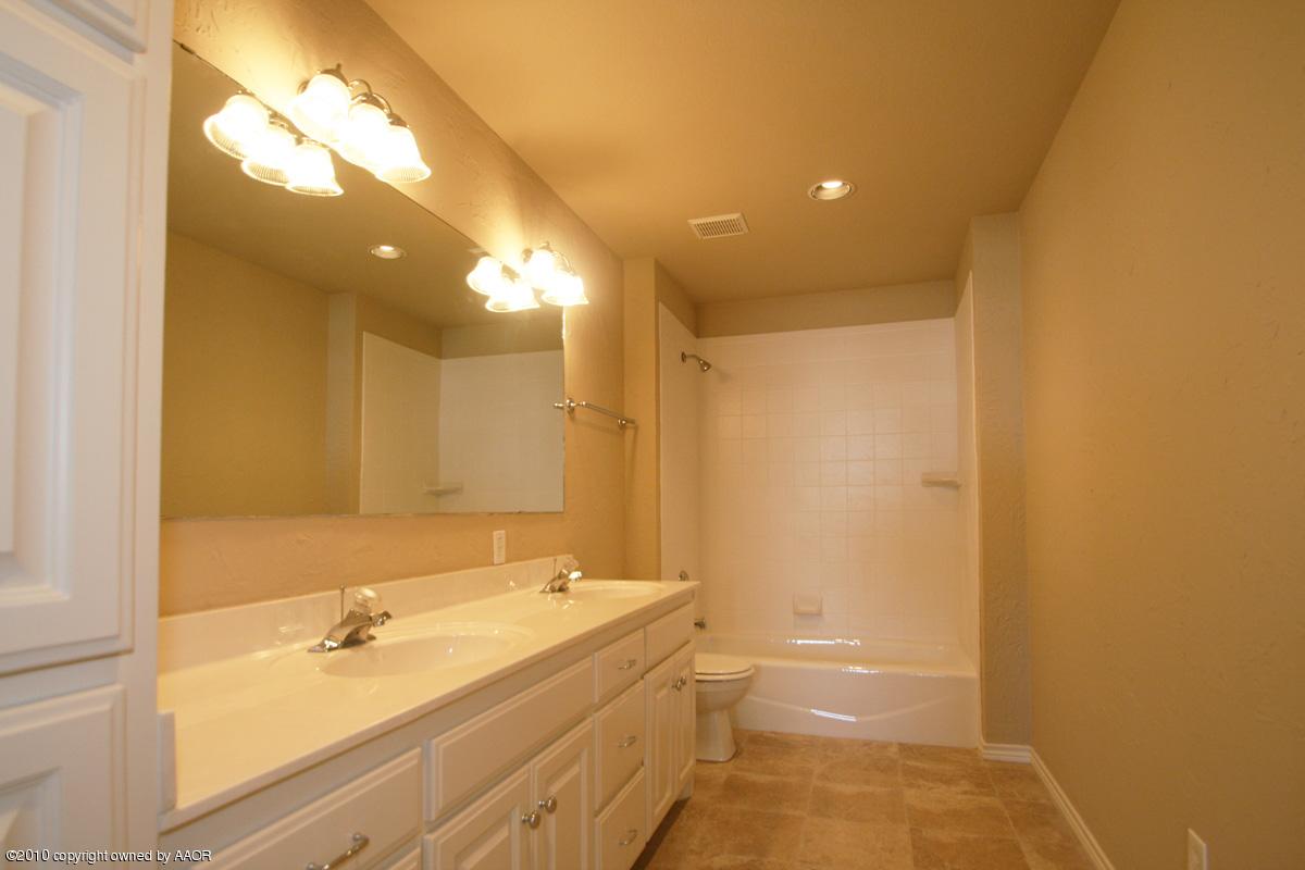 8950 Red Wing Road Amarillo, TX 79119 - Photo 23 of 29 a bathroom with a bathtub and a sink