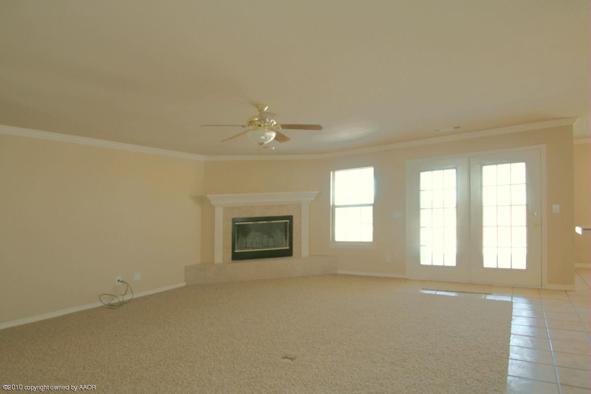 8950 Red Wing Road Amarillo, TX 79119 - Photo 6 of 29 an empty room with windows and chandelier fan