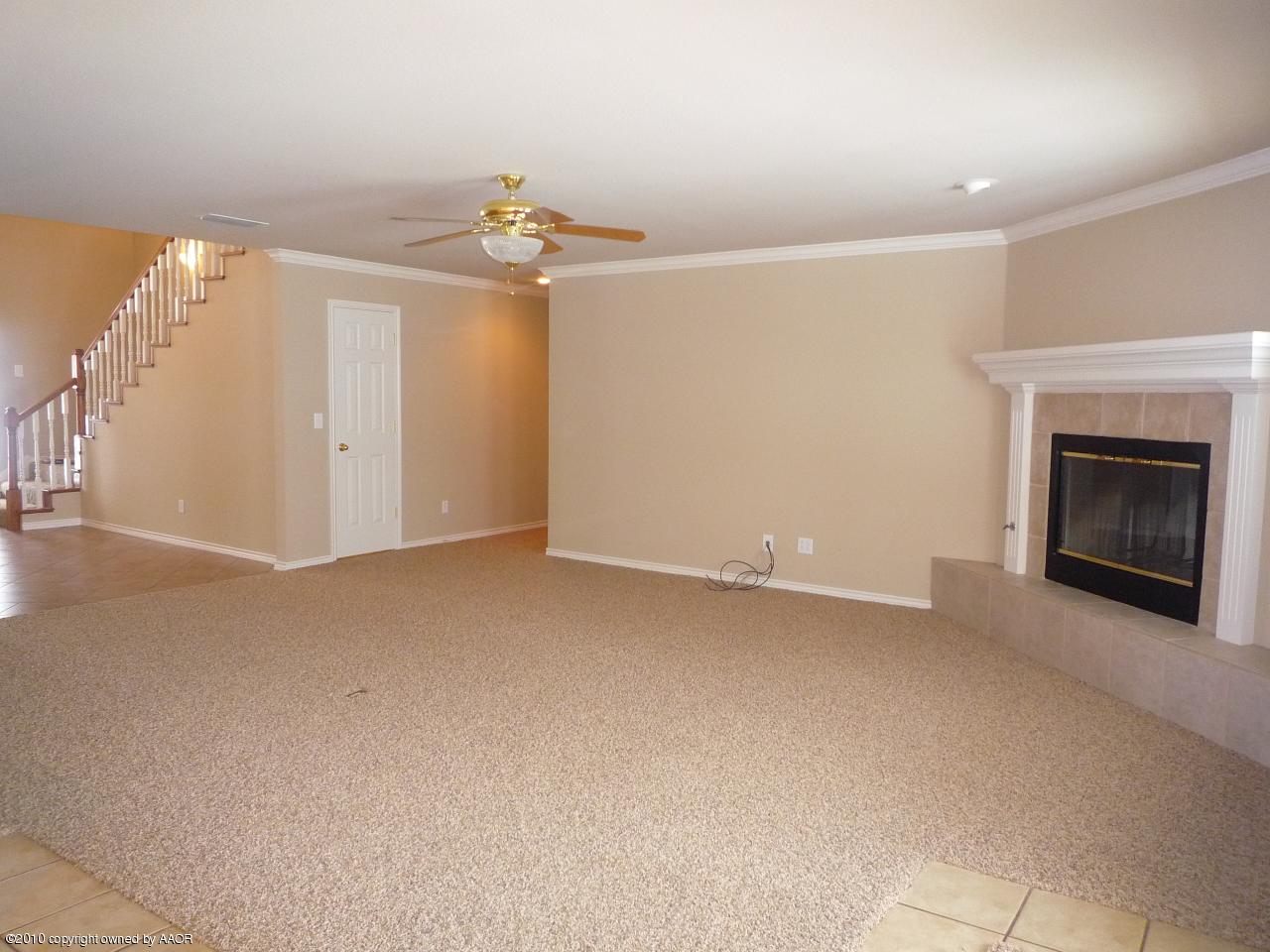 8950 Red Wing Road Amarillo, TX 79119 - Photo 7 of 29 an empty room with windows and fireplace