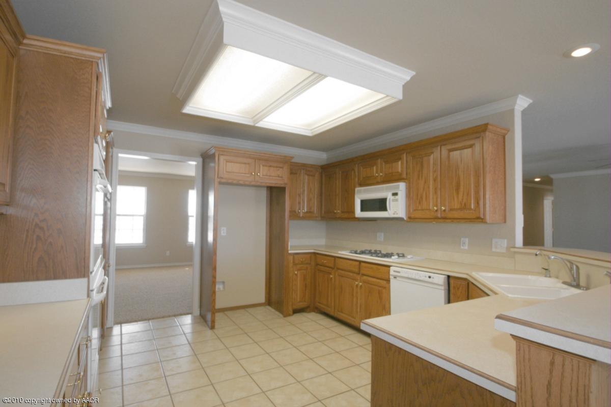 8950 Red Wing Road Amarillo, TX 79119 - Photo 9 of 29 a kitchen with a sink cabinets and stainless steel appliances