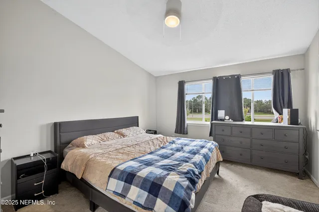 a bedroom with a bed and window