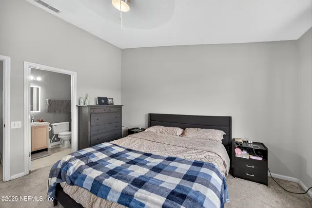 a bedroom with a bed and a lamp