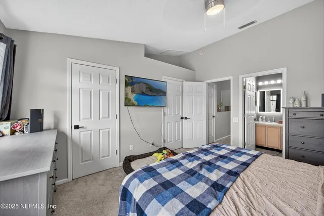 a bedroom with a bed and a view of bathroom