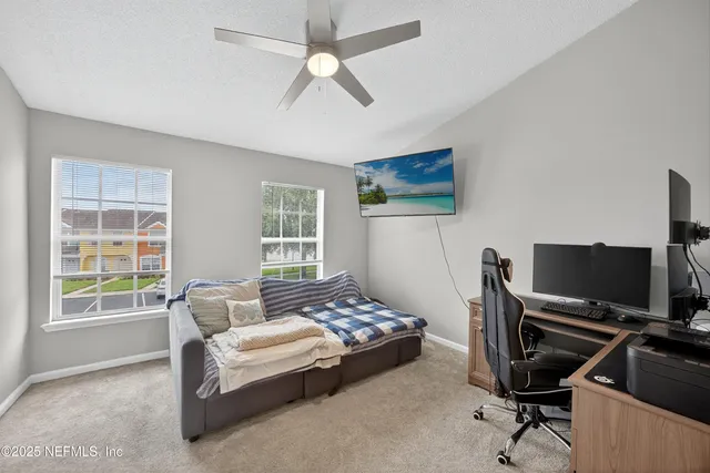 a bedroom with a bed and a desk