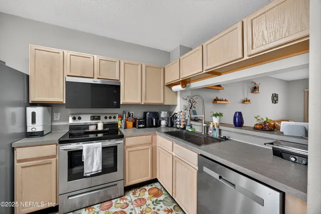 a kitchen with cabinets appliances and a sink