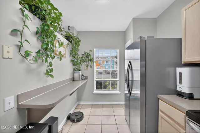 a kitchen with stainless steel appliances a refrigerator and a counter top space