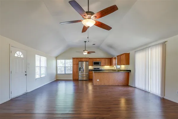a open kitchen with stove a sink and a refrigerator