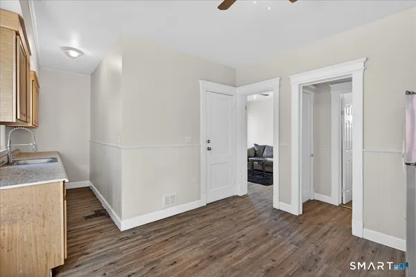 a view of a kitchen with wooden floor and a sink