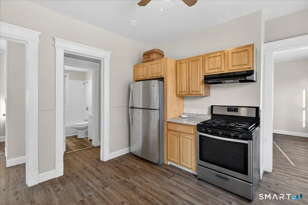 a kitchen with a stove and a refrigerator