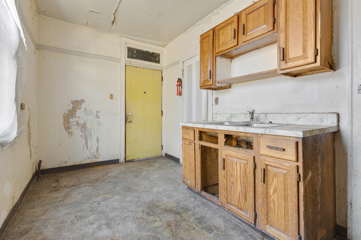 118 East 105th Street Chicago, IL 60628 - Photo 5 of 26 a kitchen with stainless steel appliances granite countertop a sink and cabinets