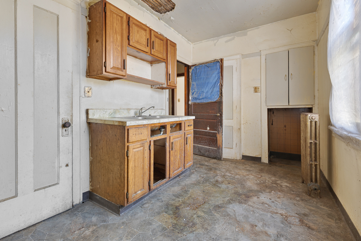 118 East 105th Street Chicago, IL 60628 - Photo 6 of 26 a view of a kitchen with stainless steel appliances granite countertop a stove and a refrigerator