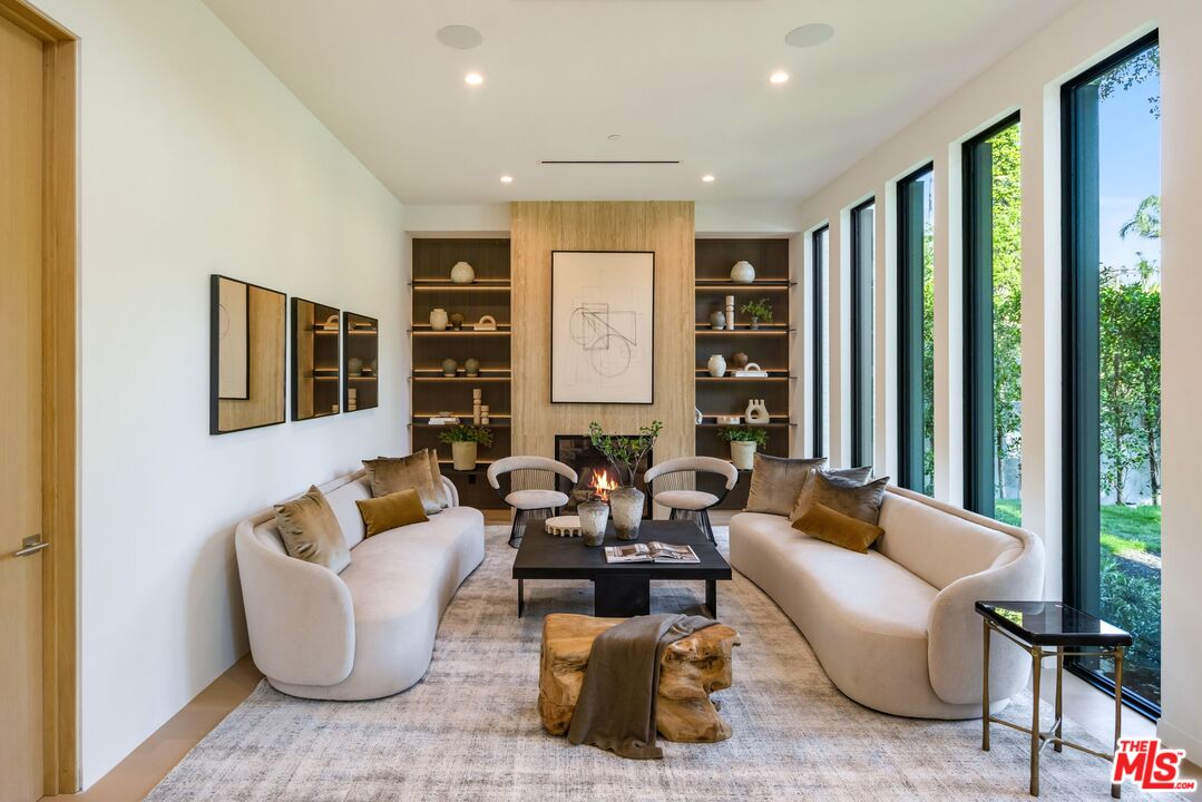 17055 Rancho Street Encino, CA 91316 - Photo 21 of 73 a living room with fireplace furniture and a large window