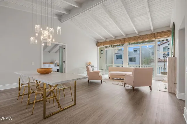 a view of a dining room with furniture window and wooden floor