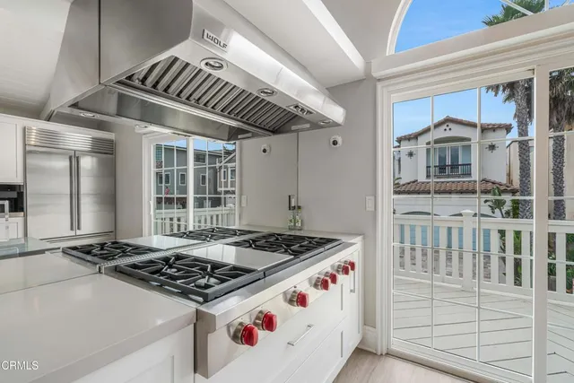 a kitchen with cabinets and wooden floor