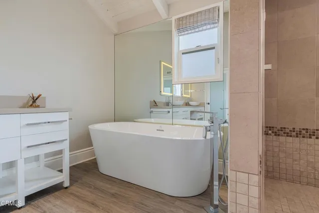 a bathroom with a bathtub and shower