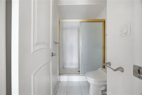 a bathroom with a shower and a toilet