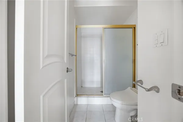 a bathroom with a shower and a toilet