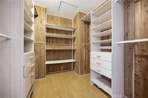 a view of walk in closet with empty racks