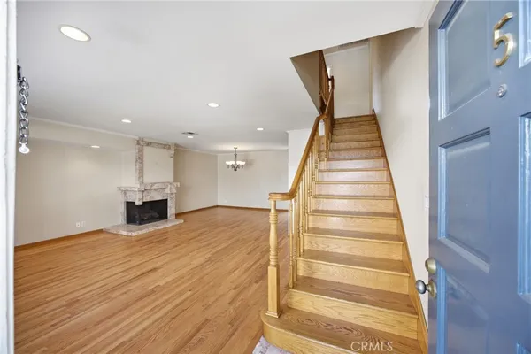 a view of a livingroom with wooden floor and staircase