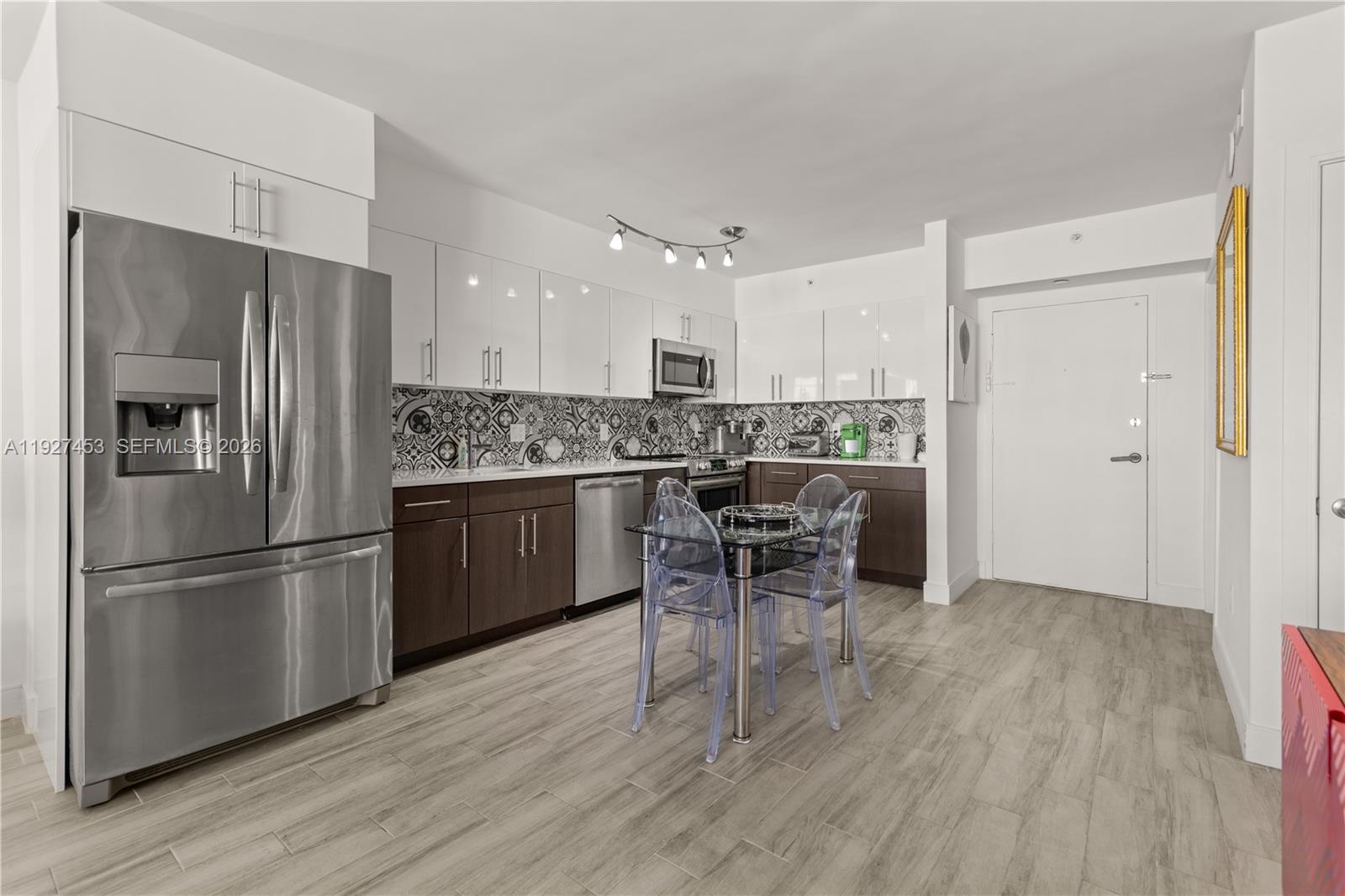 a kitchen with stainless steel appliances a refrigerator and a stove top oven