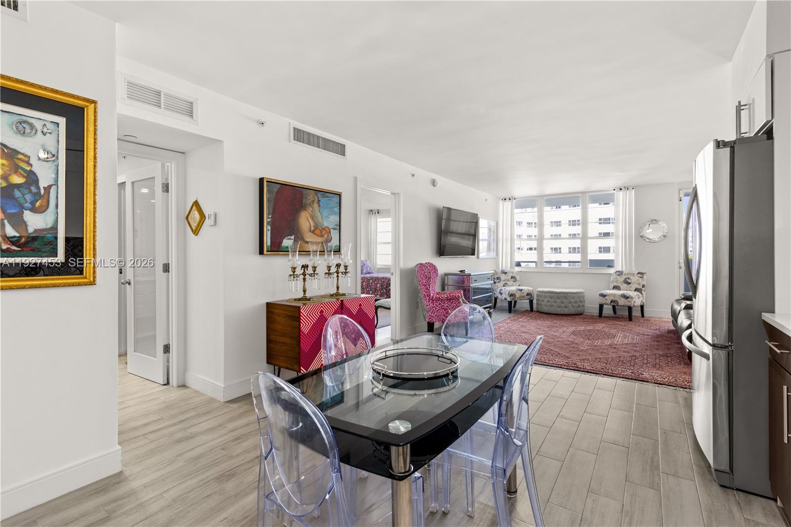 100 Lincoln Road, Unit 643 Miami Beach, FL 33139 - Photo 11 of 17 a living room with furniture a wooden floor and large window