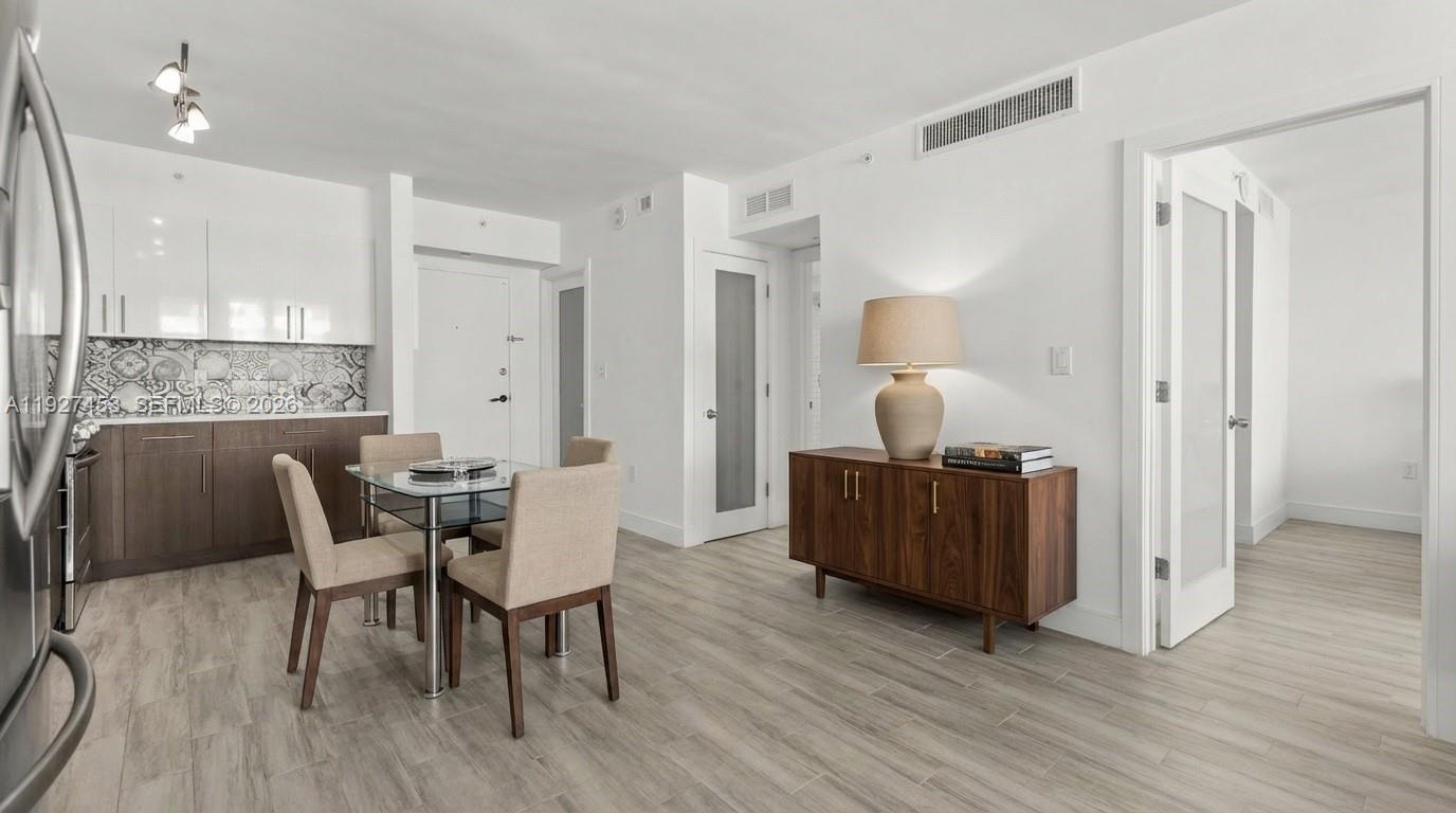 100 Lincoln Road, Unit 643 Miami Beach, FL 33139 - Photo 15 of 17 a living room with furniture and a wooden floor