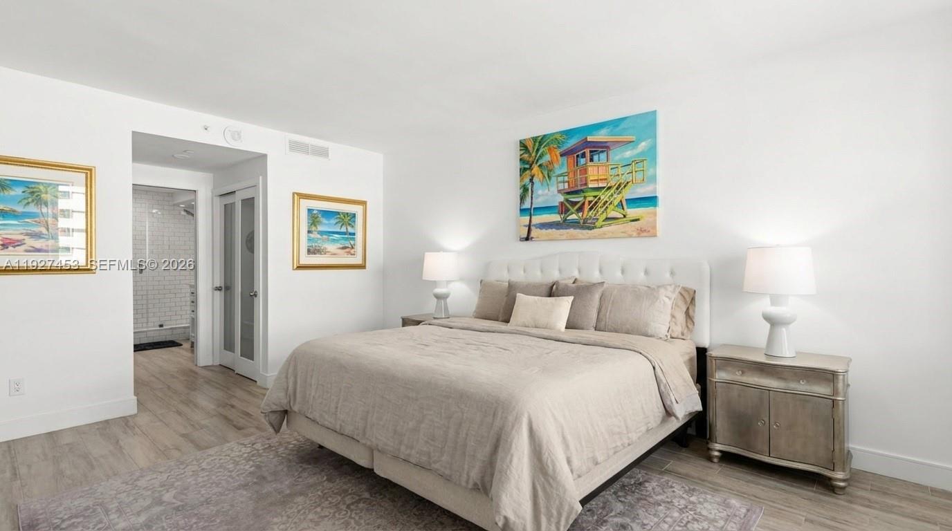 100 Lincoln Road, Unit 643 Miami Beach, FL 33139 - Photo 7 of 17 a bedroom with a bed and a view of bathroom