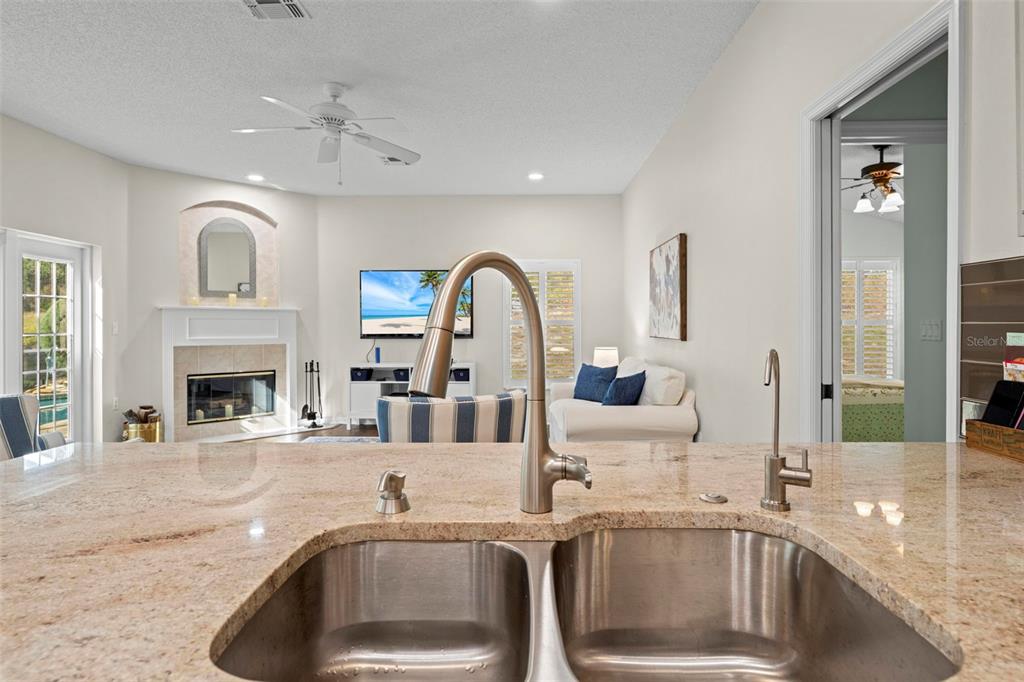 332 McIntosh Court Spring Hill, FL 34609 - Photo 13 of 54 a view of a kitchen with a sink and living room