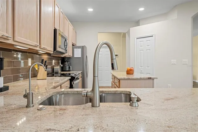 a kitchen with stainless steel appliances a sink and a counter top space