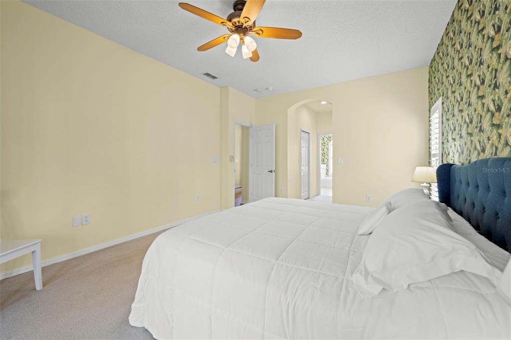 332 McIntosh Court Spring Hill, FL 34609 - Photo 32 of 54 a bedroom with a bed and a chandelier