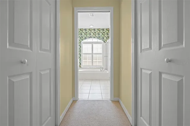a spacious bathroom with a bathtub sink and mirror