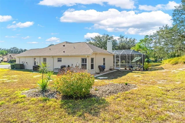 a view of a white house with a swimming pool and a yard