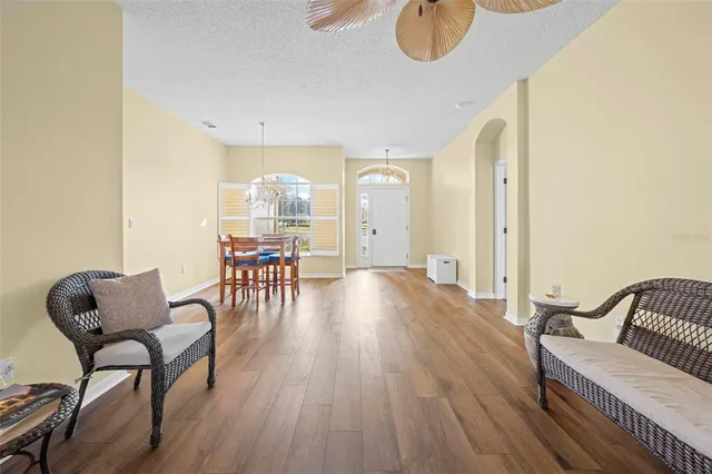 a living room with furniture and a chandelier