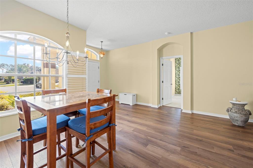 332 McIntosh Court Spring Hill, FL 34609 - Photo 7 of 54 a view of a dining room with furniture and wooden floor