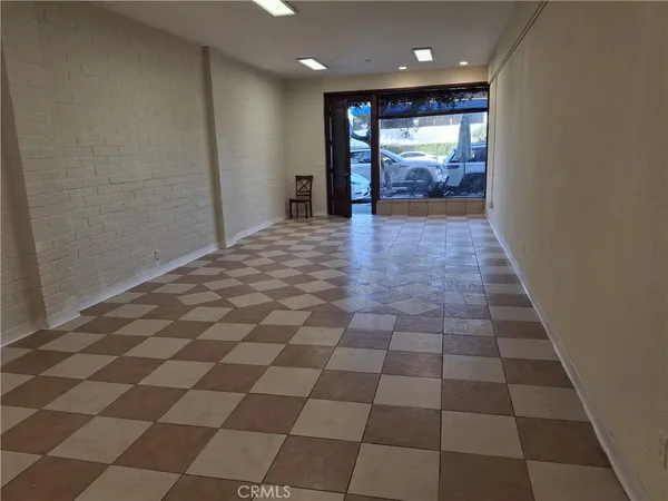 a view of hallway with a window and a kitchen