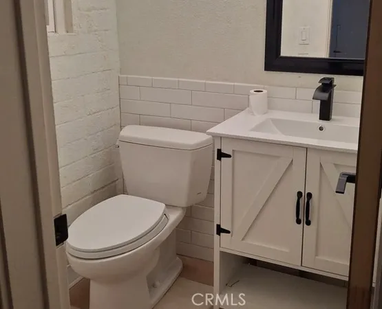 a white toilet sitting next to a bathroom sink