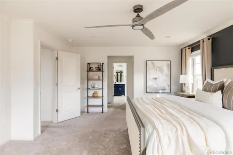 a bedroom with a large bed and a flat tv screen