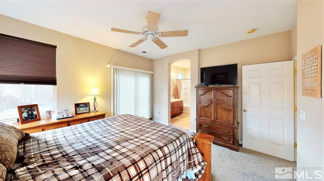10615 Arbor Way Reno, NV 89521 - Photo 14 of 23 a bedroom with a bed and a television