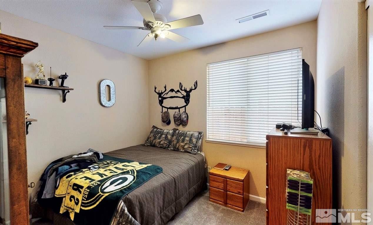 10615 Arbor Way Reno, NV 89521 - Photo 19 of 23 a bedroom with a bed and a chandelier