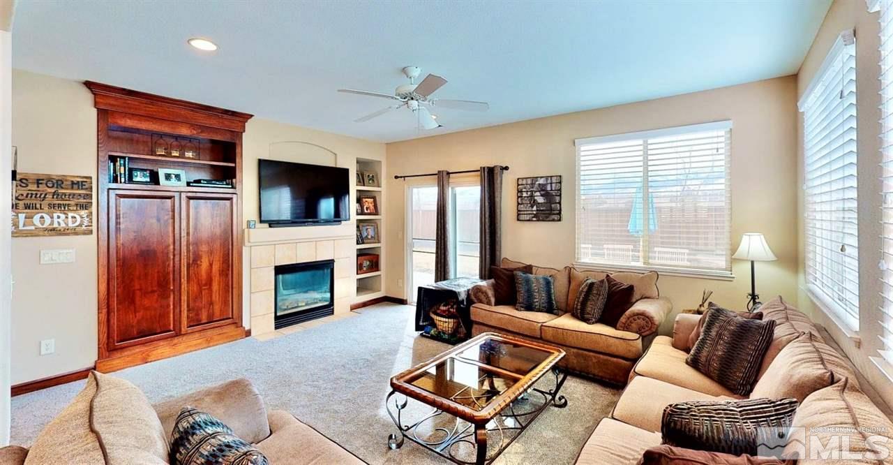 10615 Arbor Way Reno, NV 89521 - Photo 10 of 23 a living room with furniture a fireplace and a flat screen tv
