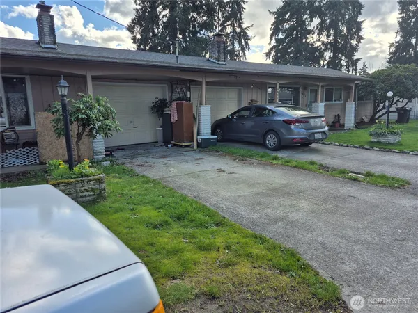 a front view of a house with a garden and plants