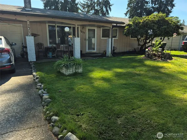 a view of a house with backyard sitting area and garden