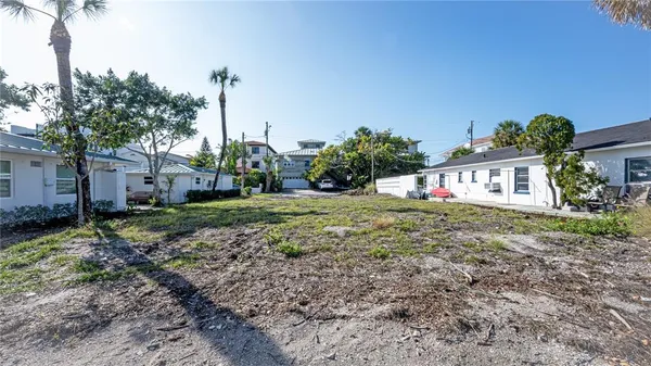 a view of a house with a yard and potted plants