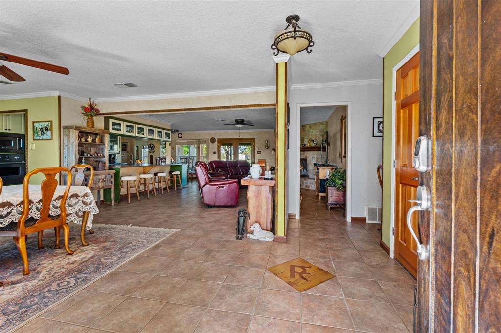 905 Ballew Springs Road Weatherford, TX 76088 - Photo 12 of 40 a living room with furniture and a chandelier
