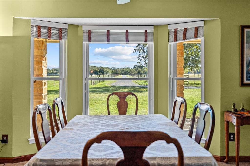 905 Ballew Springs Road Weatherford, TX 76088 - Photo 18 of 40 a view of a dining room with furniture window and wooden floor