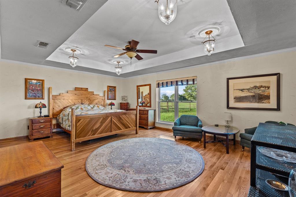 905 Ballew Springs Road Weatherford, TX 76088 - Photo 19 of 40 a bedroom with furniture and a wooden floor